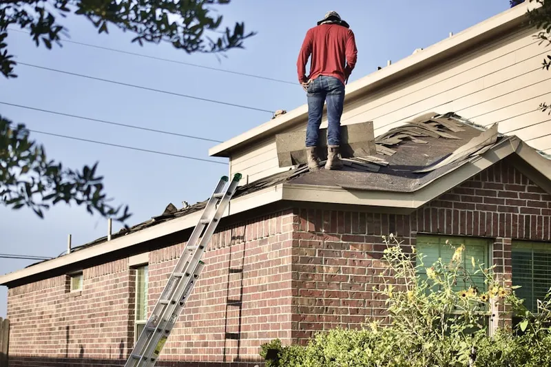 Professional roofer working on a residential roof in Floydville